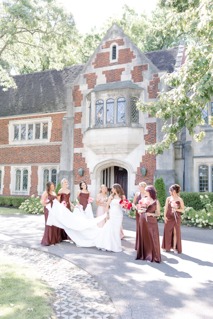Photo of bride and bridesmaids effortlessly enjoying wedding day at Cincinnati's iconic wedding venue: Pinecroft at Crosley Estate